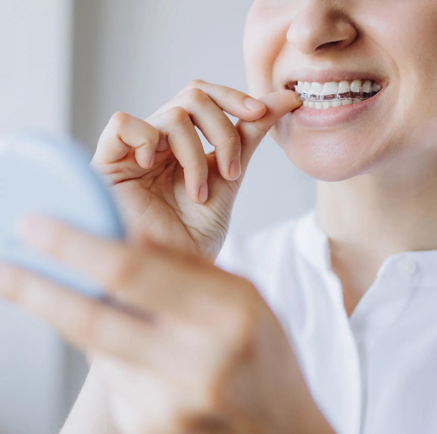 Woman putting aligners on