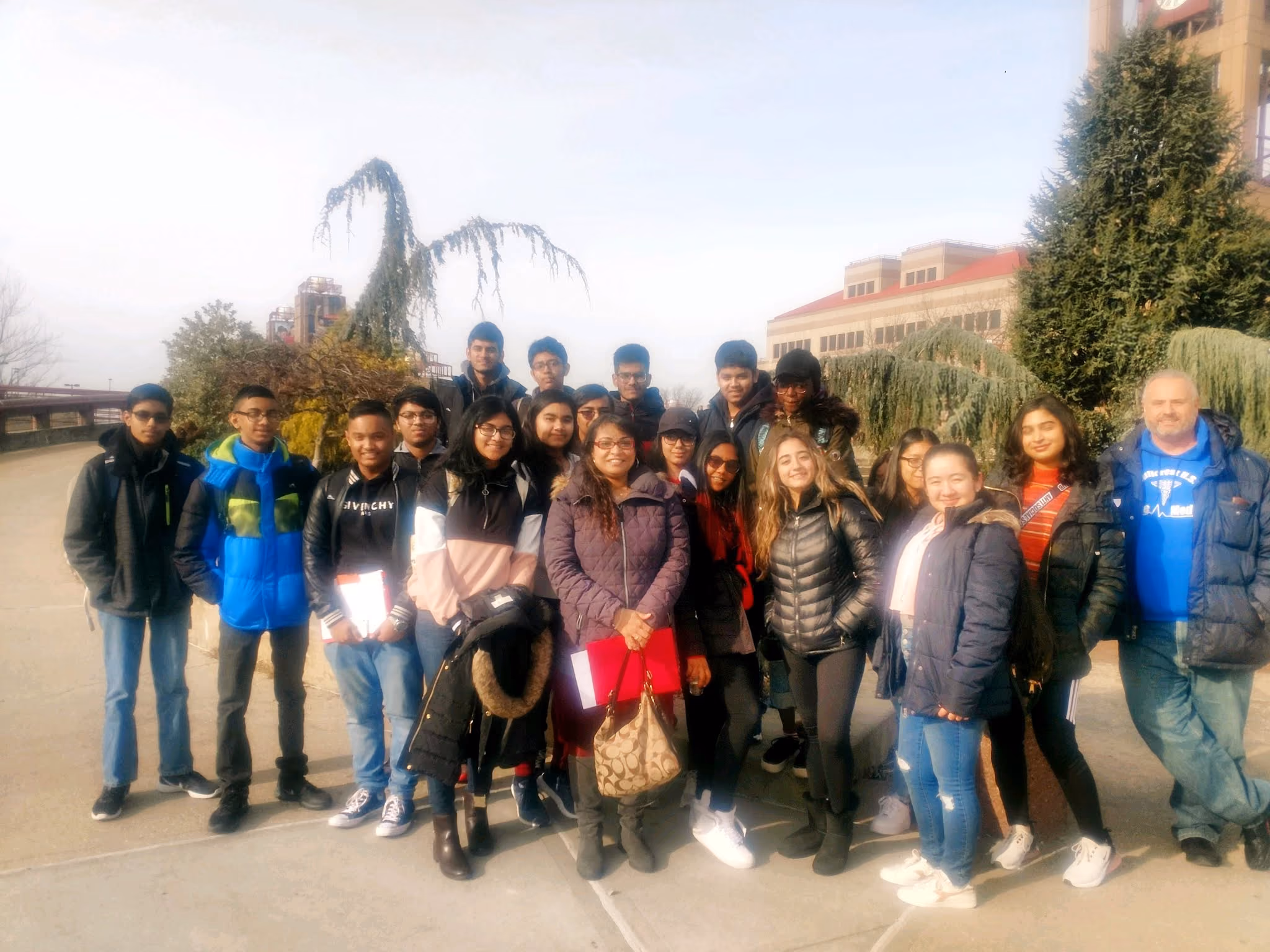 Students and chaperones pose outdoors on a winter field trip