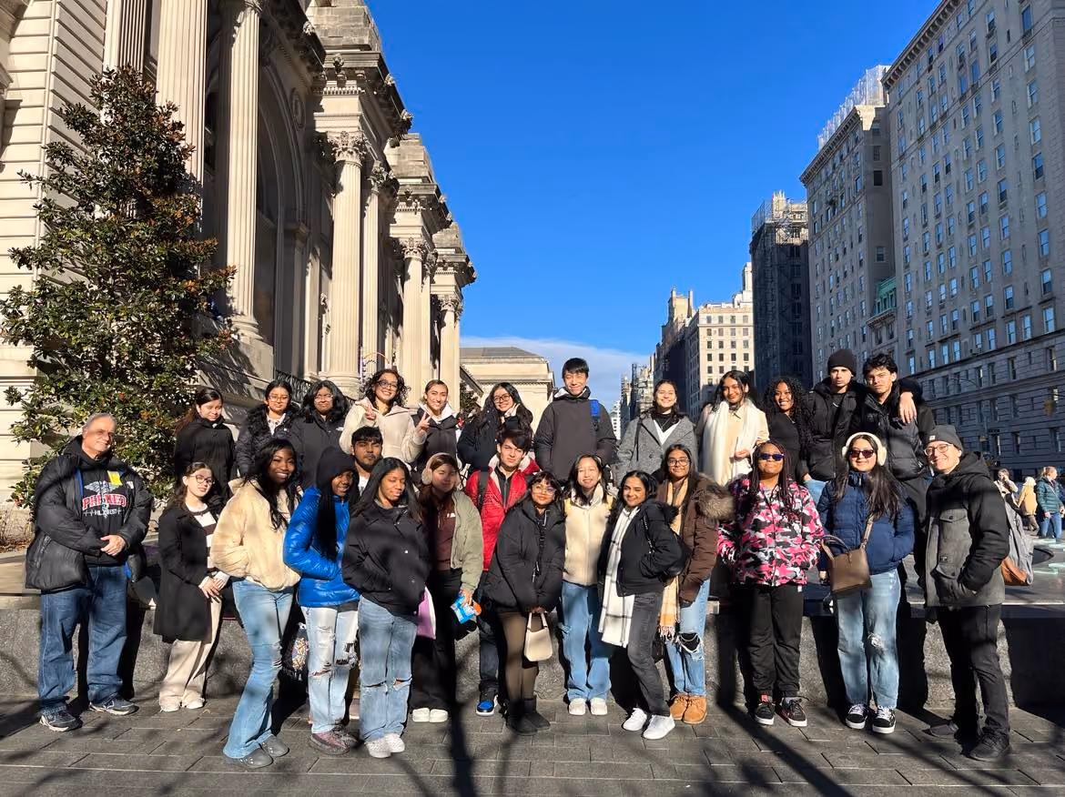 Students and chaperones posing outside the Metropolitan Museum of Art