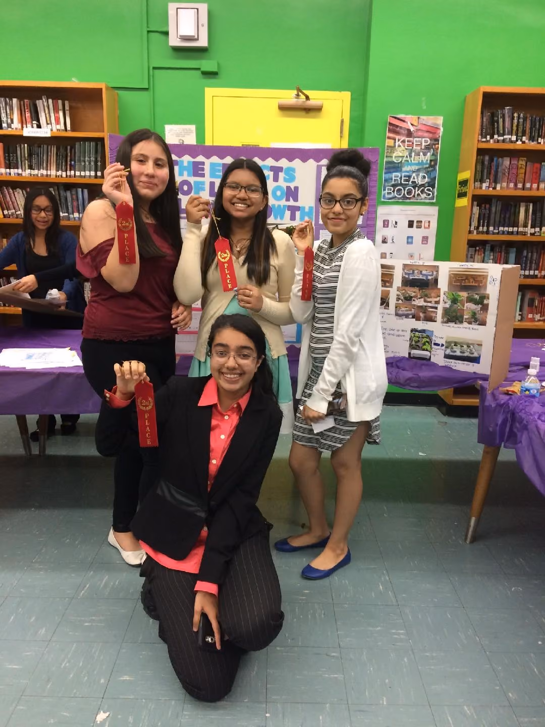Four students holding second place ribbons at school science fair