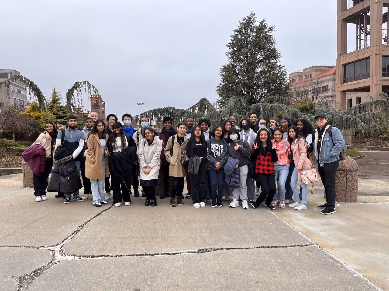 Students posing for group photo on college campus field trip