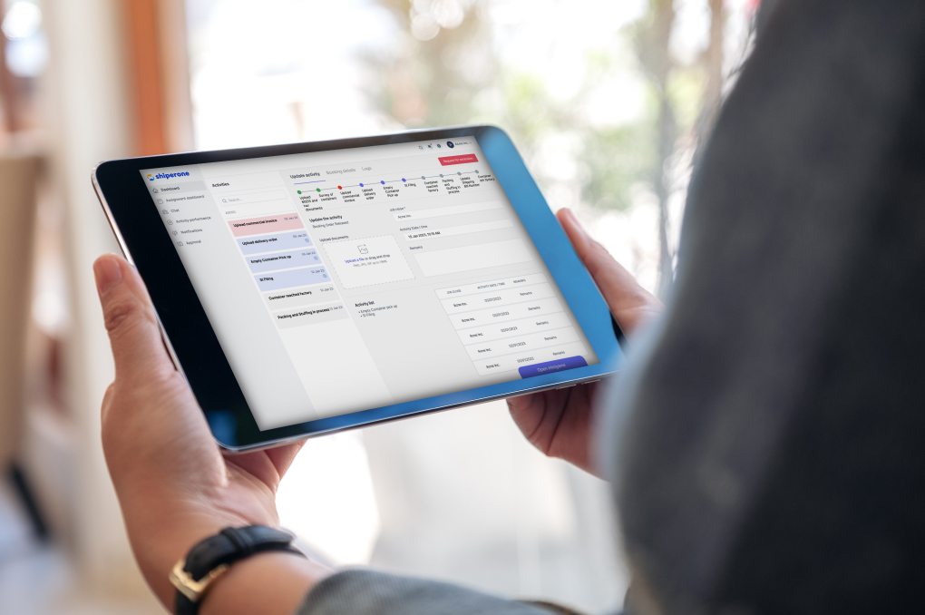 Person on close-up holnding tablet on which screen is the Shiperone Workflows Platform.