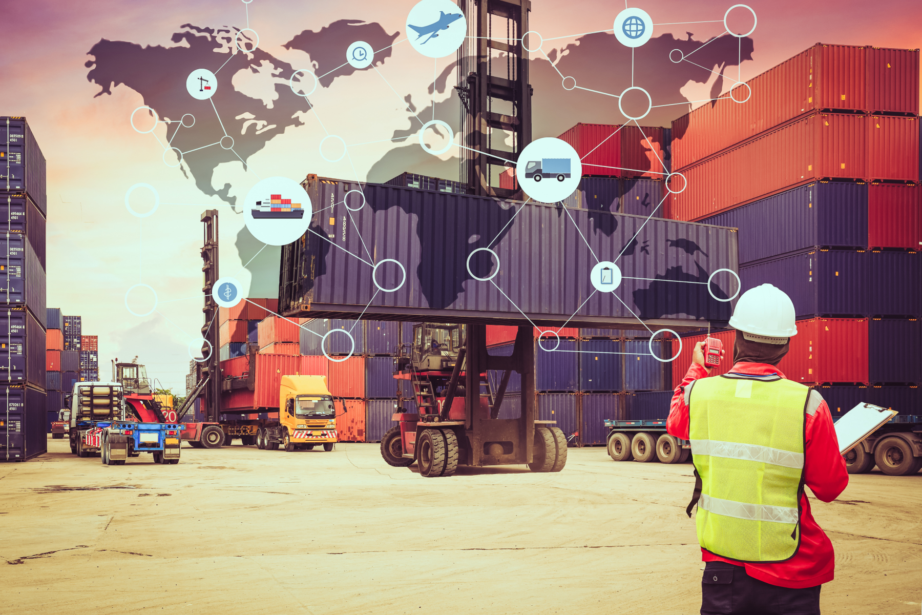 A man on a harbour in front of many containers.