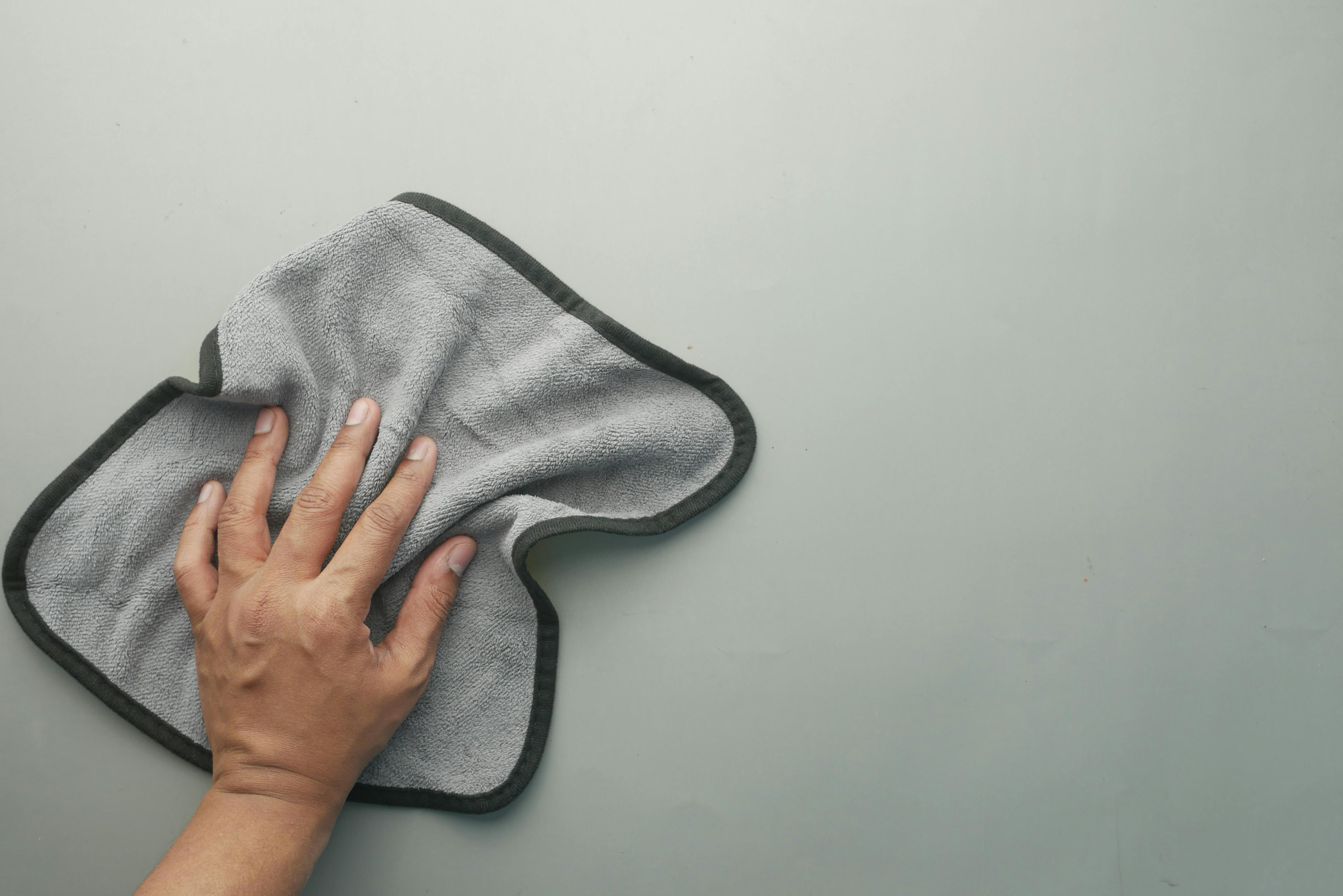 microfiber rag cleaning an indoor wall