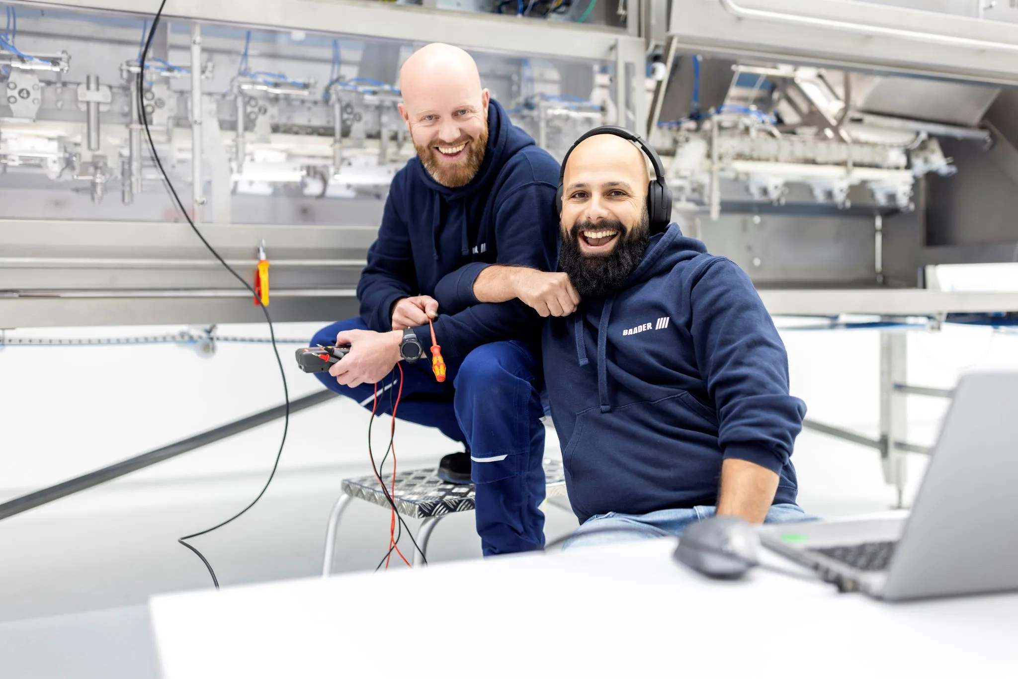 2 BAADER employees smiling and having fun during work