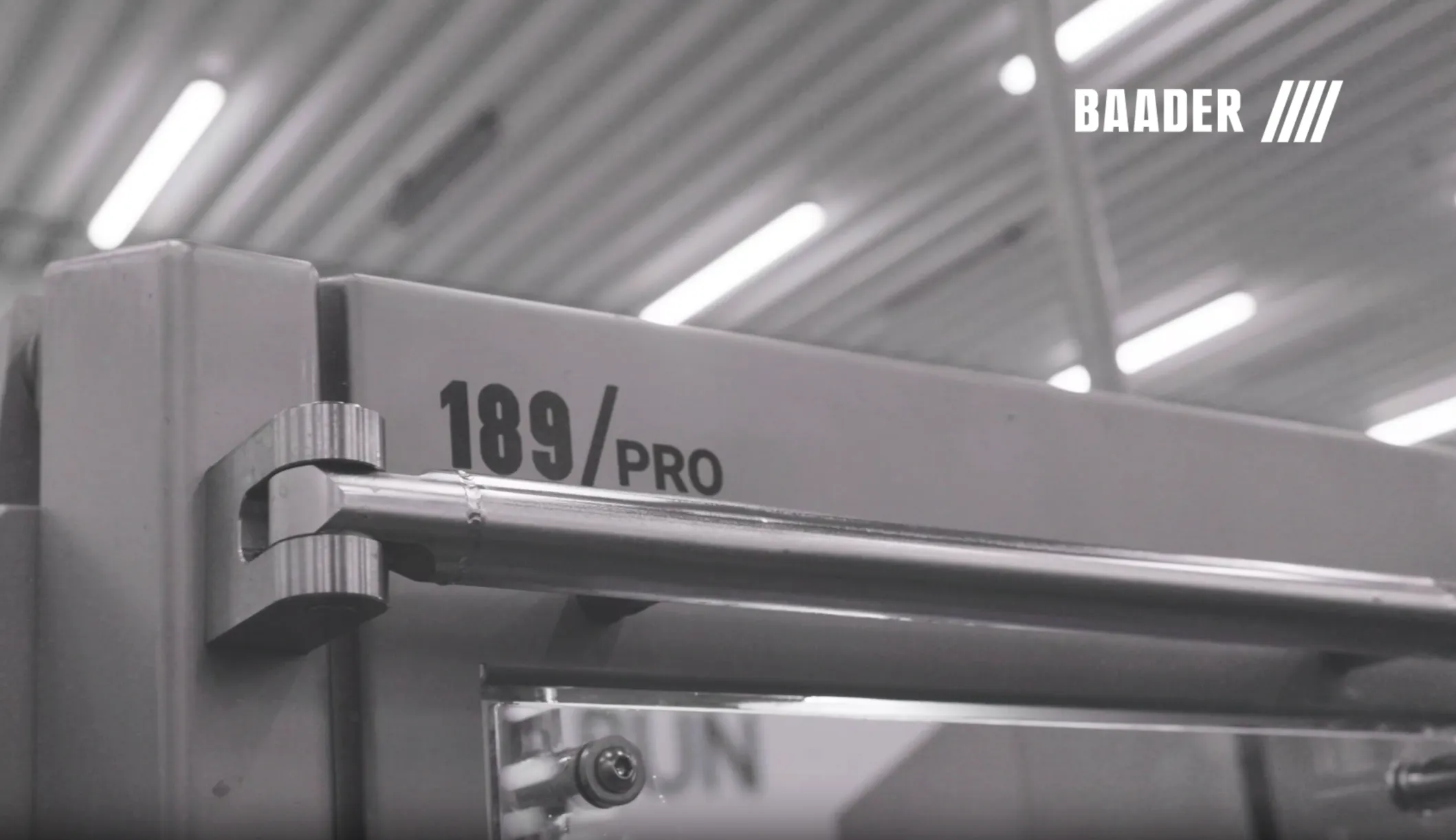 Close-up of a Baader 189 Pro machine door handle with the Baader logo visible in the top right corner.