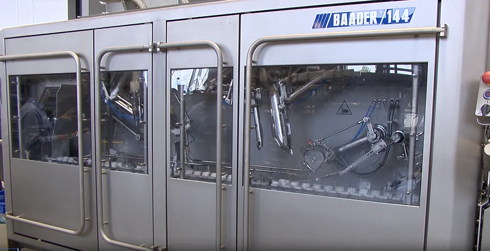 Baader 144 industrial machine with stainless steel frame and glass windows showing internal mechanical parts.