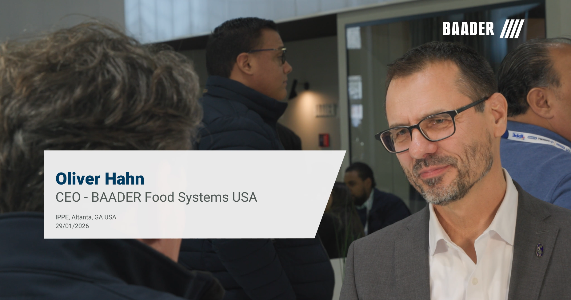 Oliver Hahn, CEO of BAADER Food Systems USA, wearing glasses and a gray suit, standing at IPPE event in Atlanta, GA, January 29, 2026.
