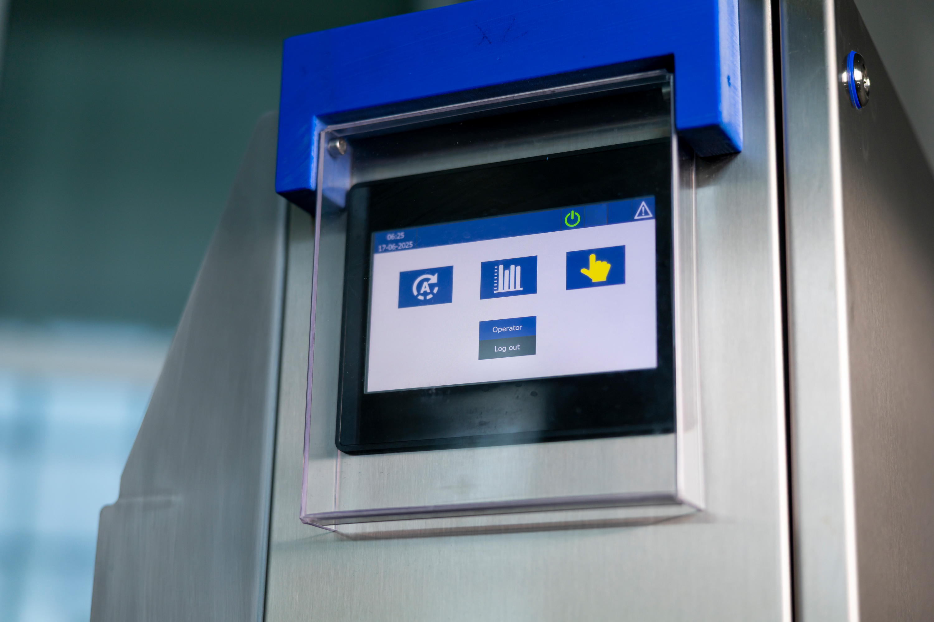 Industrial machine touchscreen panel displaying operator login options and icons.