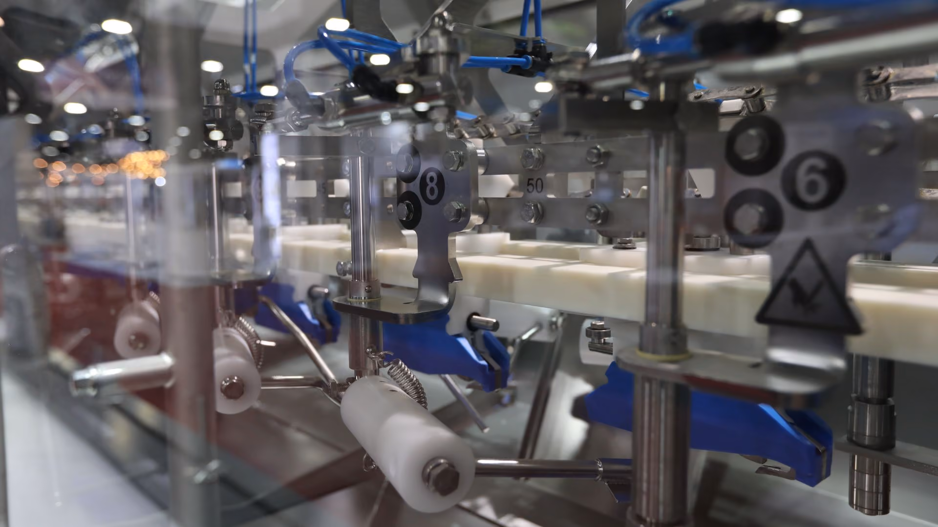 Close-up of metal parts and mechanisms inside an industrial packaging machine.