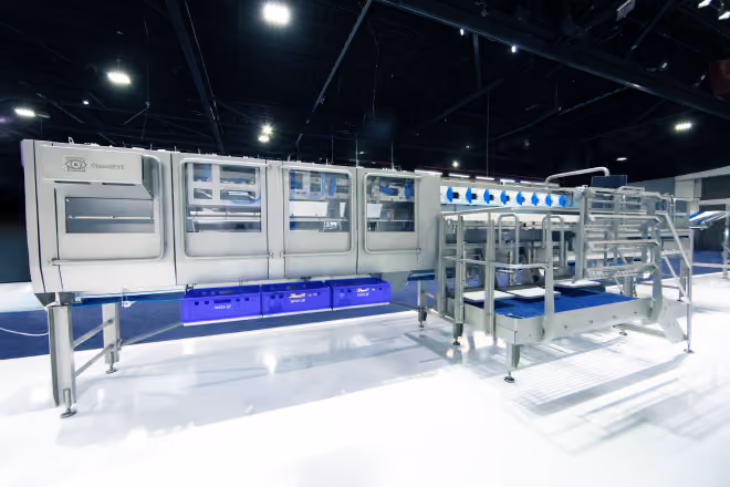 Large industrial sorting machine with transparent panels and metallic frame in a brightly lit space.