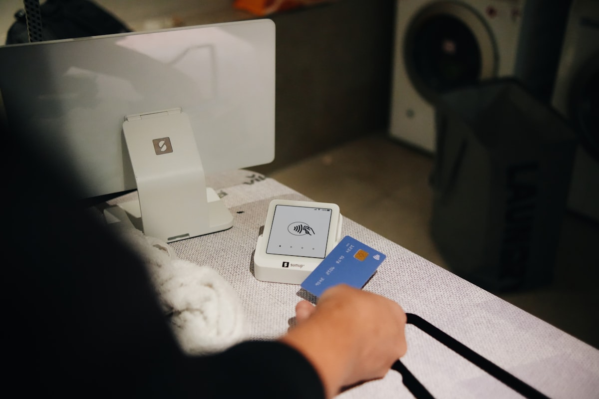 UK tradesman accepting a card payment on a mobile card machine at a job site