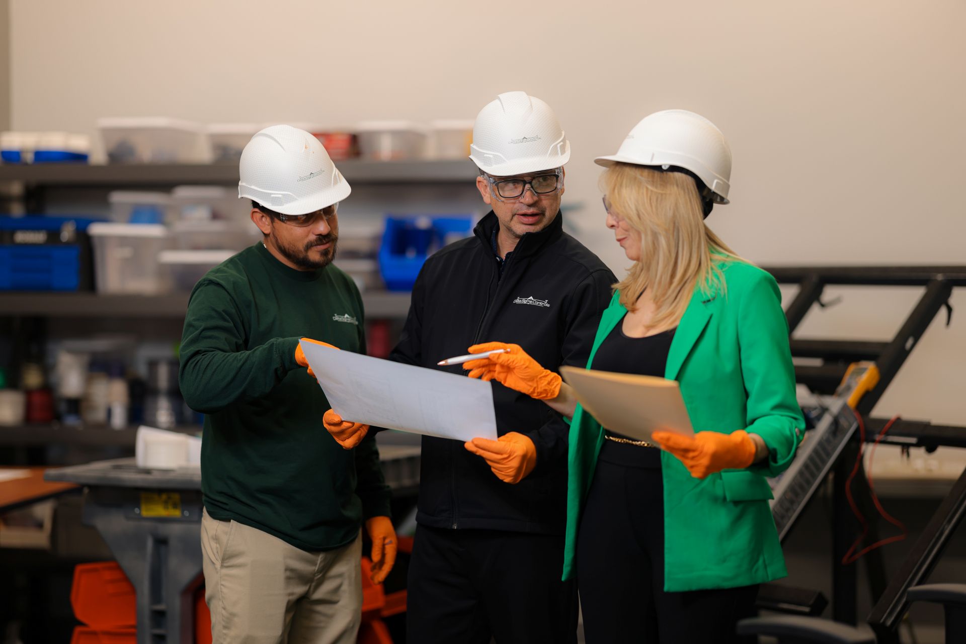 a group of people wearing hard hats and holding a piece of paper