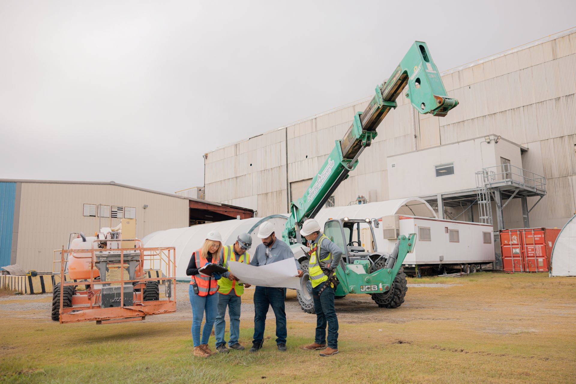 a group of people standing next to a crane
