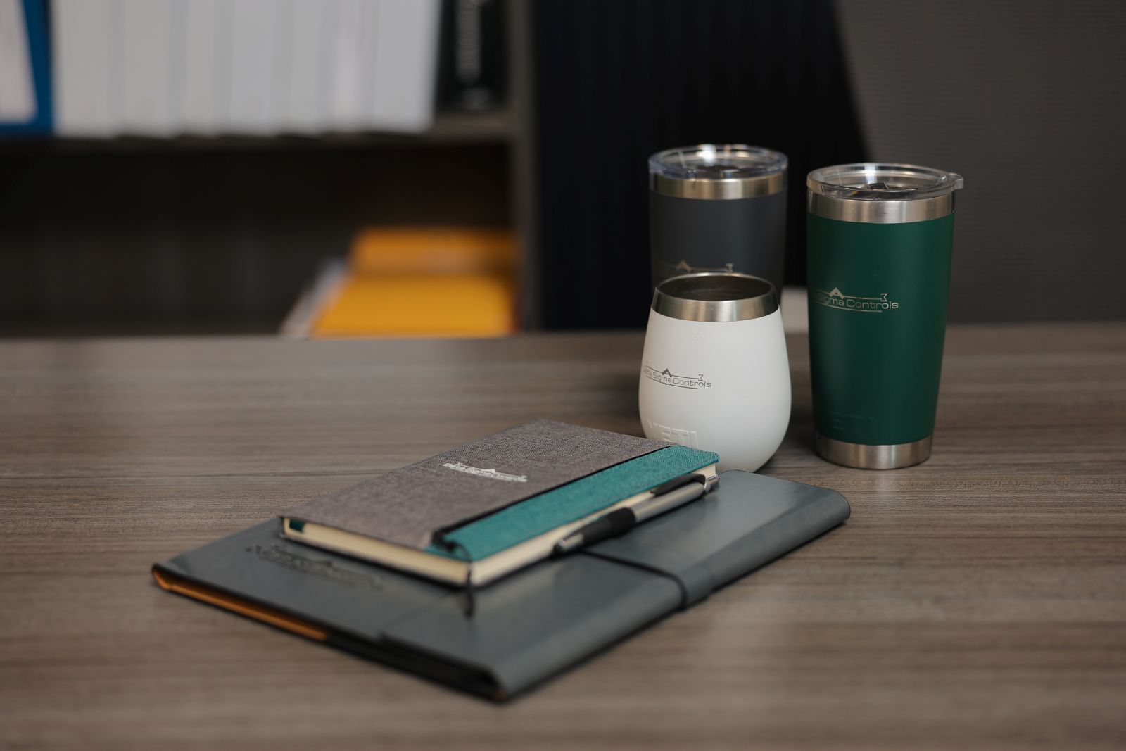 a notebook and two cups on a table