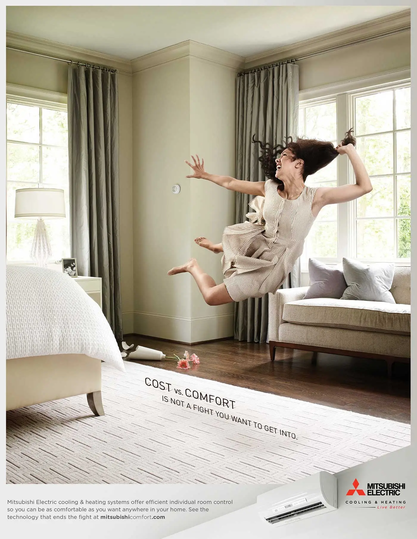 Mitsubishi Electric print ad with woman throwing herself across the bedroom and headline that reads Cost versus Comfort is not a fight you want to get into.