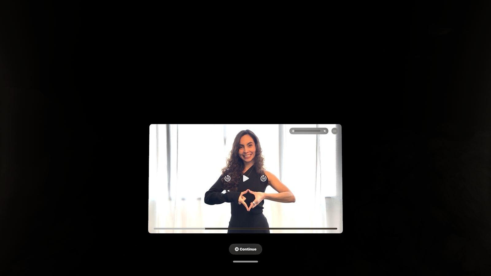 Juliana Hoyos demonstrating the light trigger gesture with both hands in the app's introduction video.
