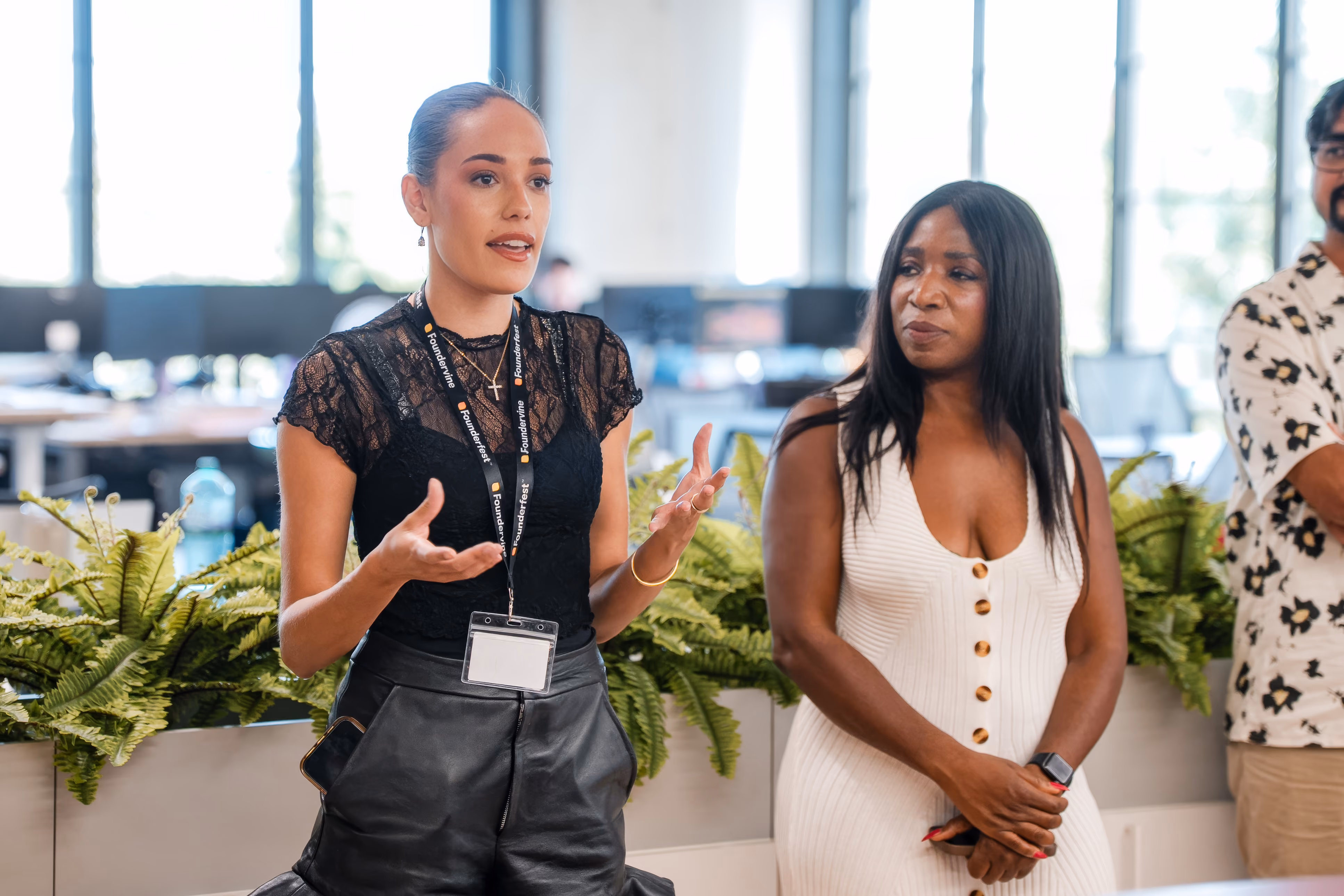 A woman giving a speech with another standing next to her