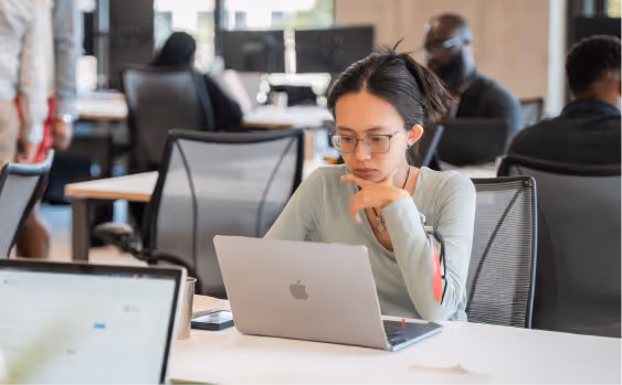 A focused woman behind her laptop