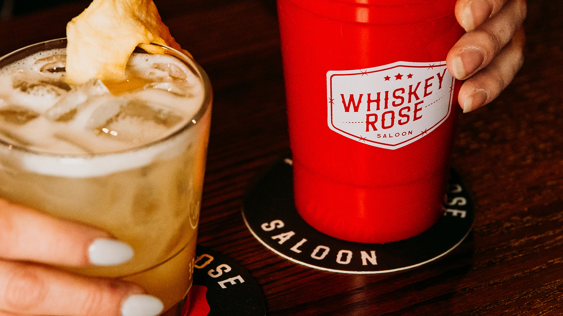 Whiskey Rose logo design on a solo cup and coaster