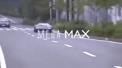 A black supercar racing down the street