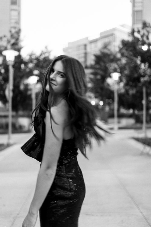 College senior portait outside. Turning and smiling at camera