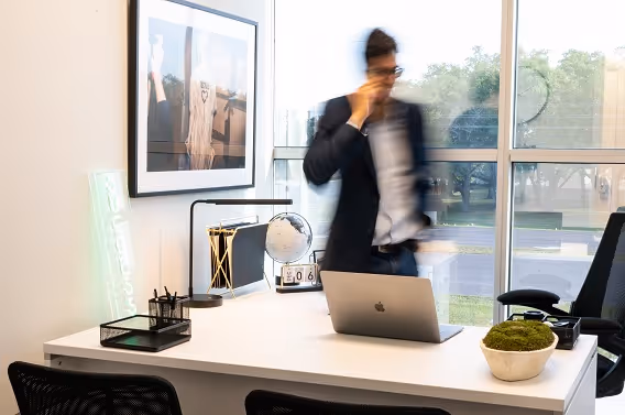 Spacious and furnished executive suite at The Worx Orlando, featuring a large desk, ergonomic chair, and modern decor