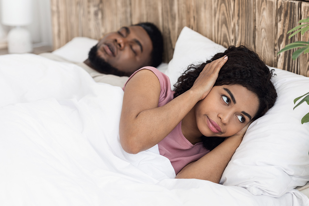 Photo of a woman who is bothered by snoring
