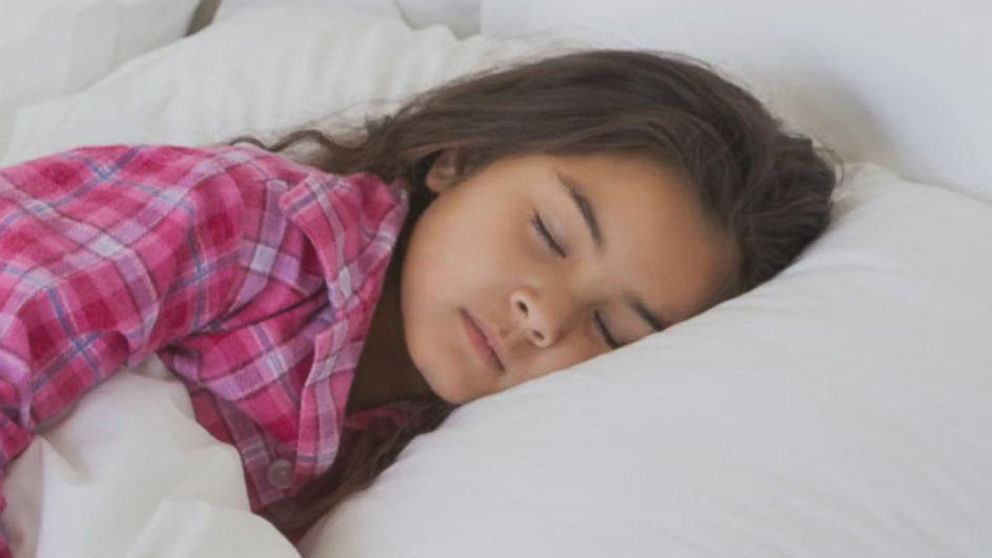 A photo of a sleeping girl wearing a pink shirt