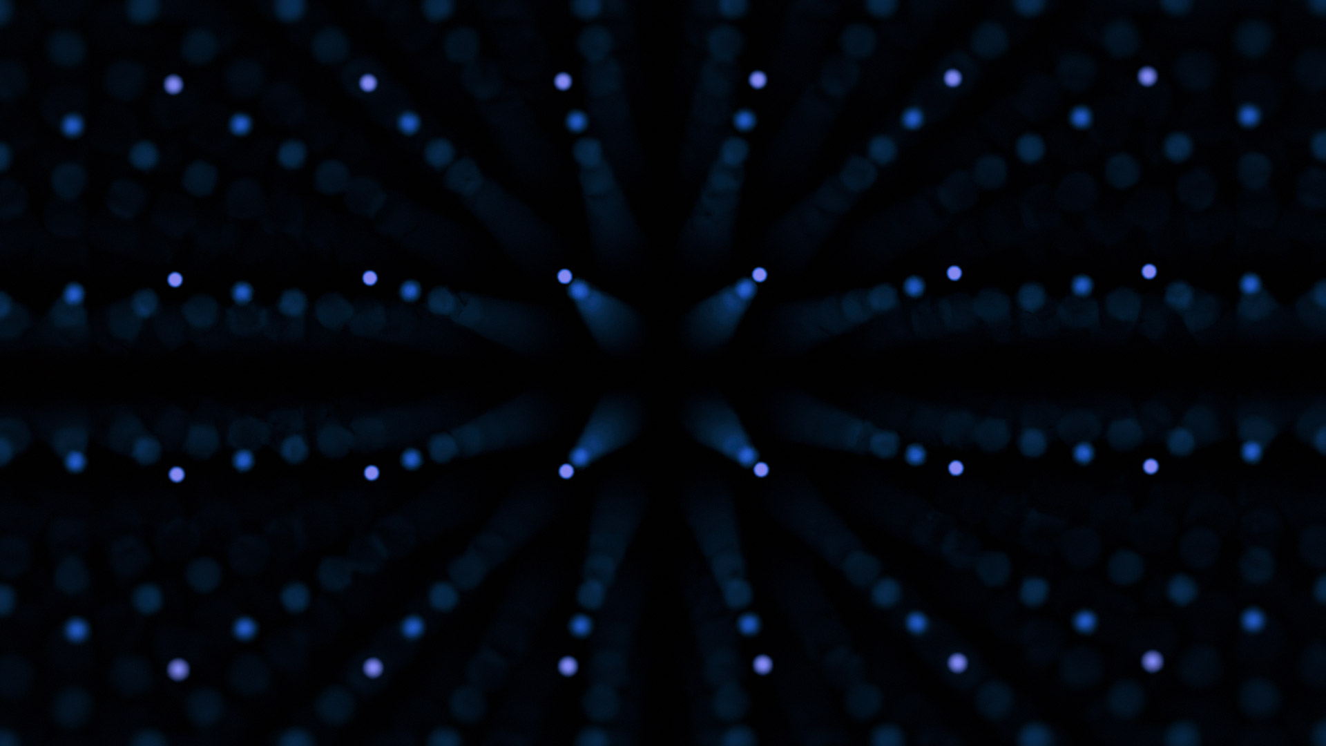 Blue dotted lights are shown against a black background.