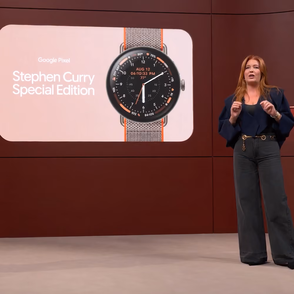 Presenter standing on stage next to a screen introducing the Google Pixel Stephen Curry Special Edition watch.