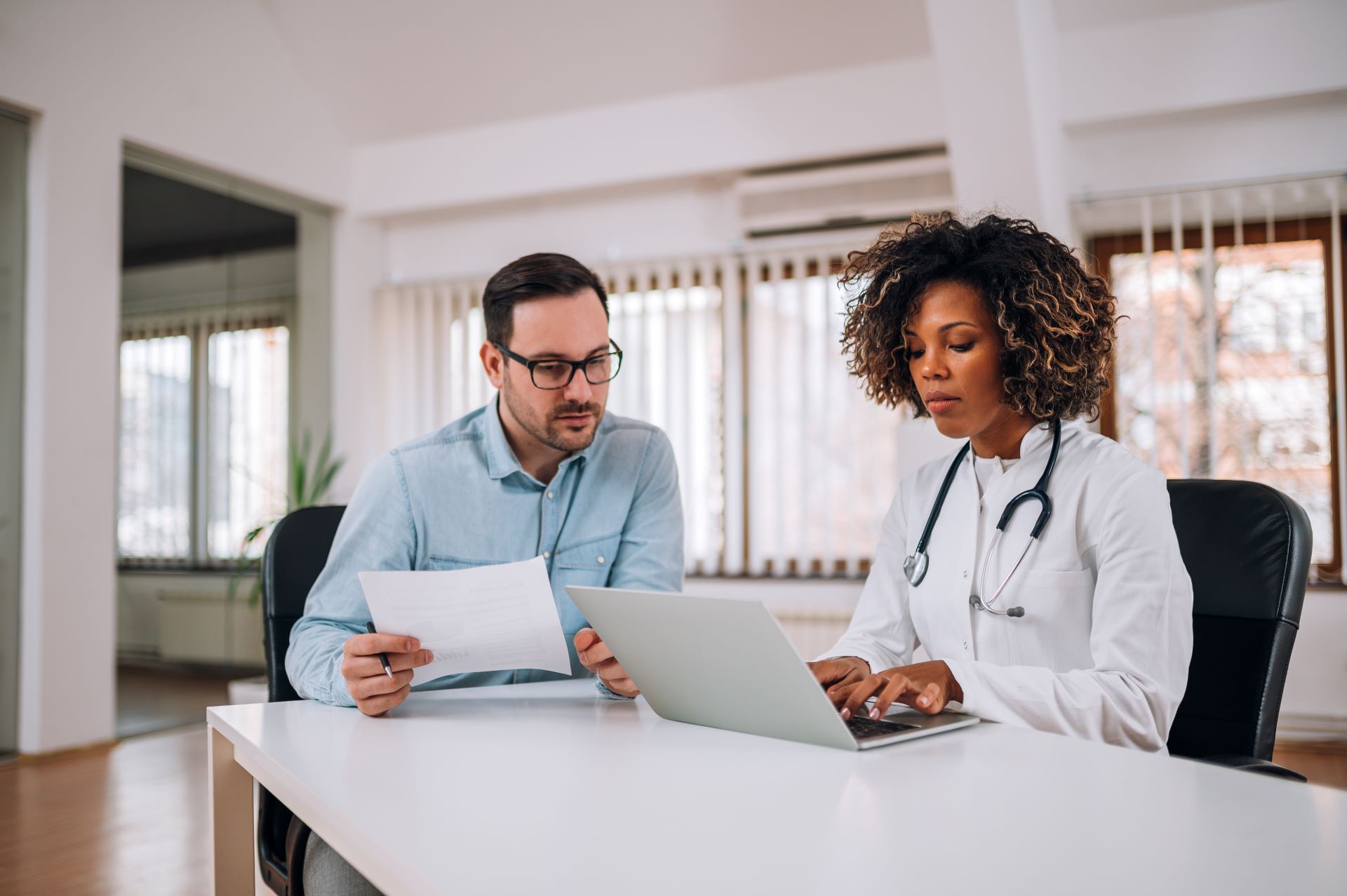 Administrator and physician having a serious conversation