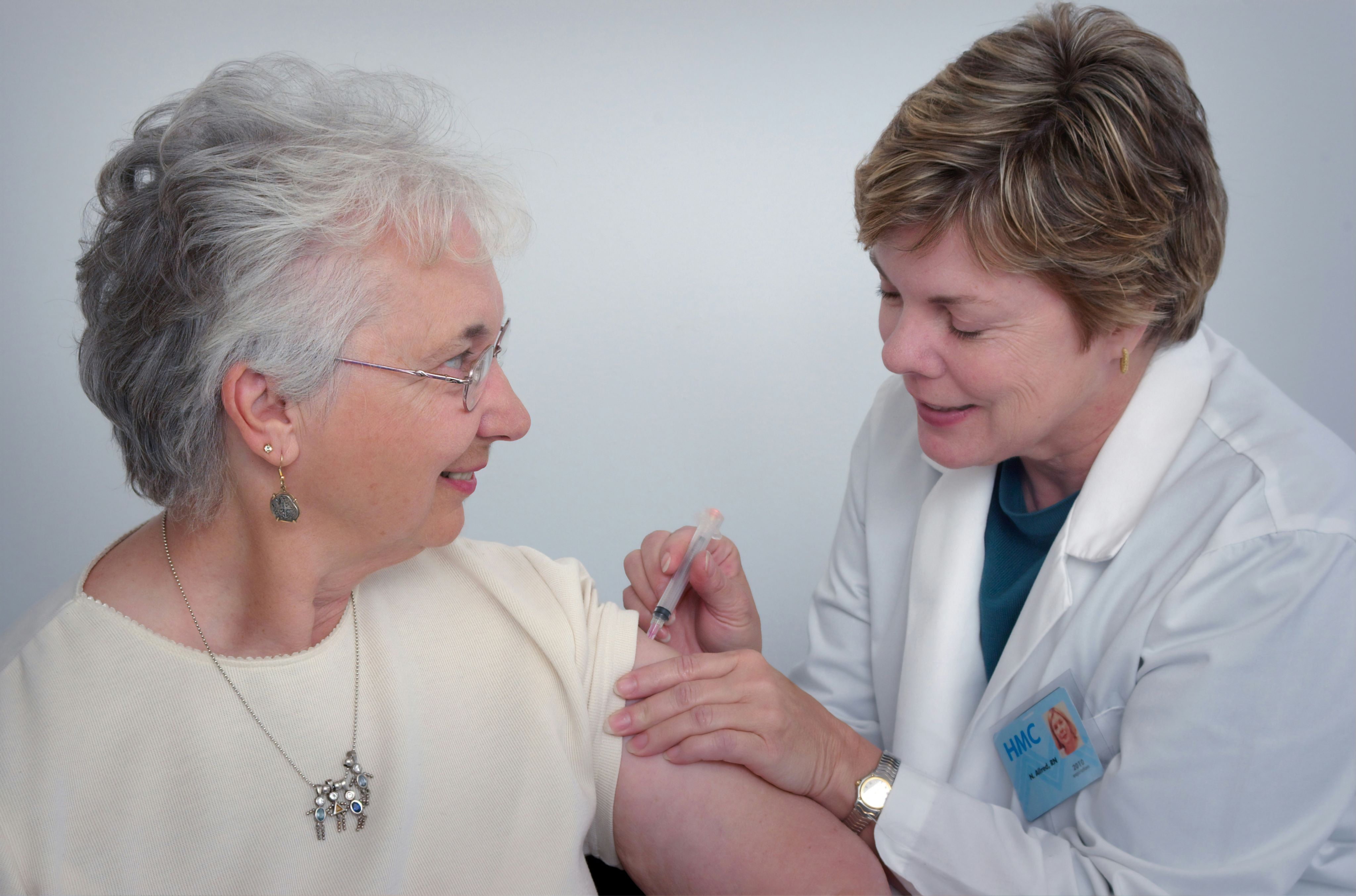 Female patient getting a vaccine from a female clinician