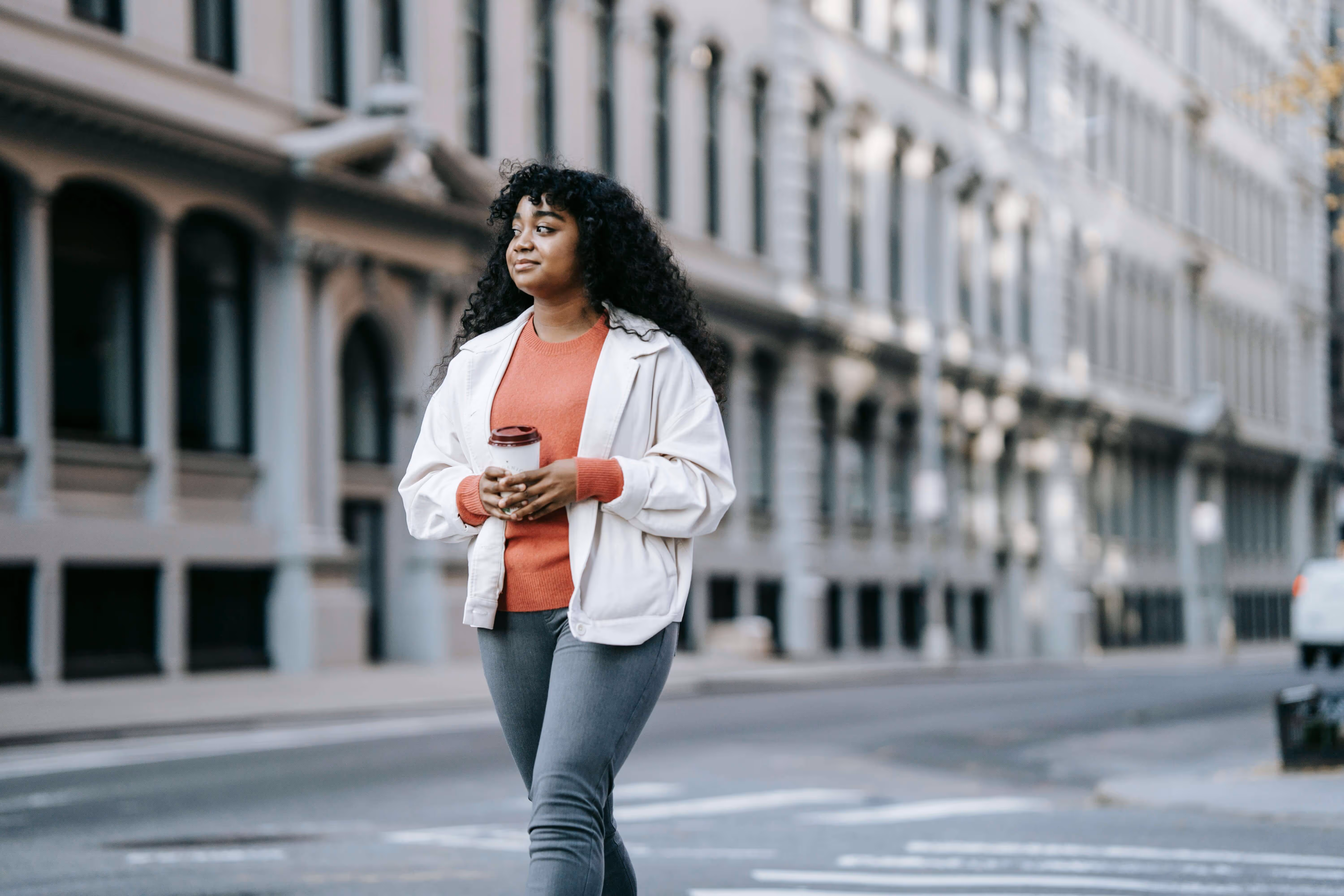 Woman walking in the street with coffee