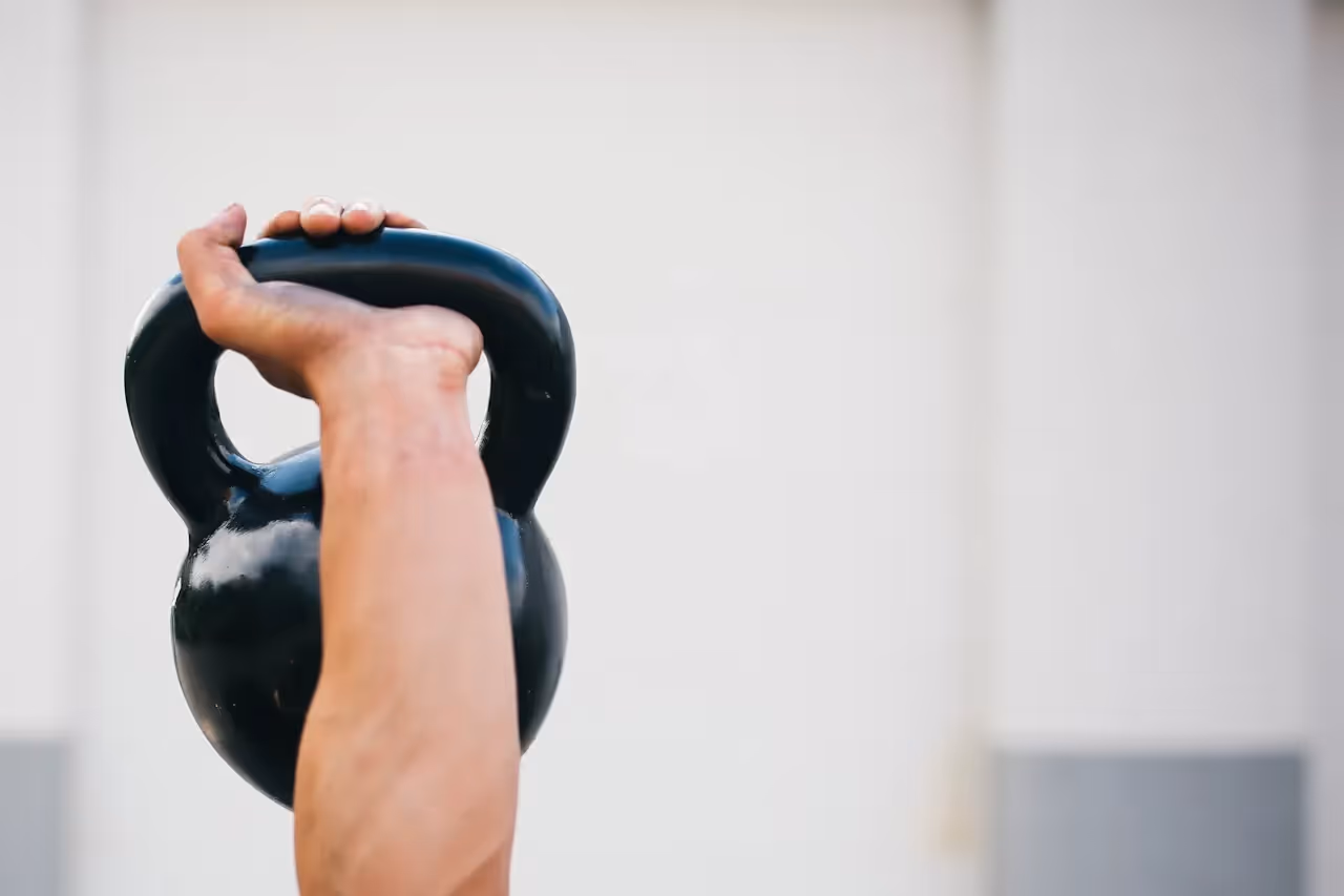 Arm holding up a kettle bell