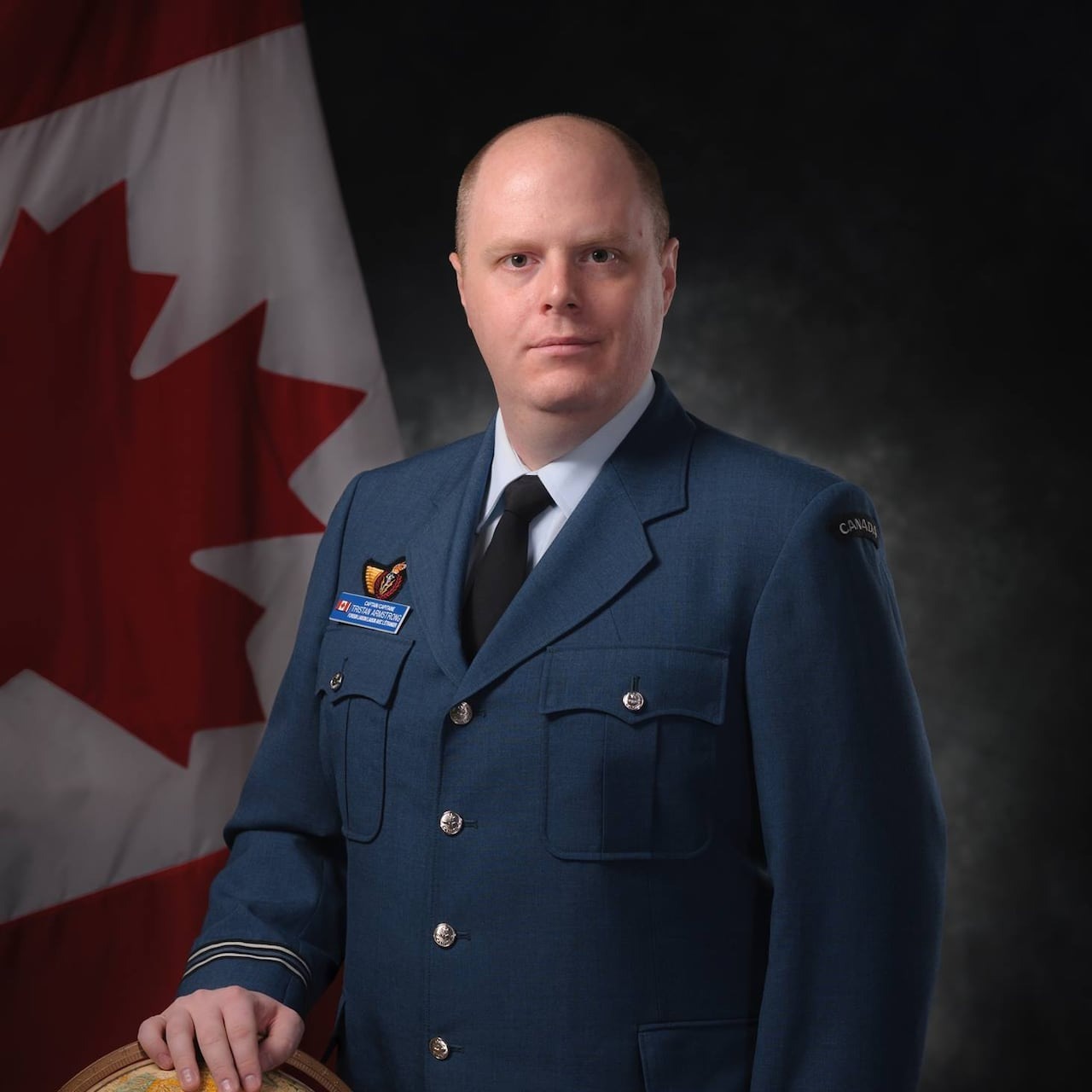 A man wearing a uniform poses for a photo.