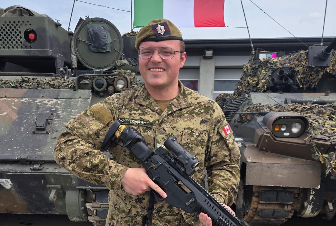 A man in a uniform and carrying a firearm.