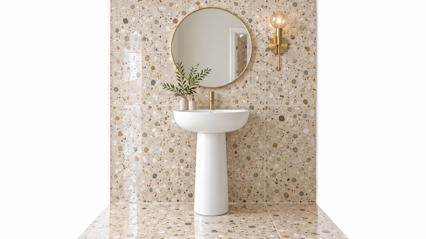 A modern bathroom vanity featuring a white pedestal sink against a beige terrazzo tile wall.