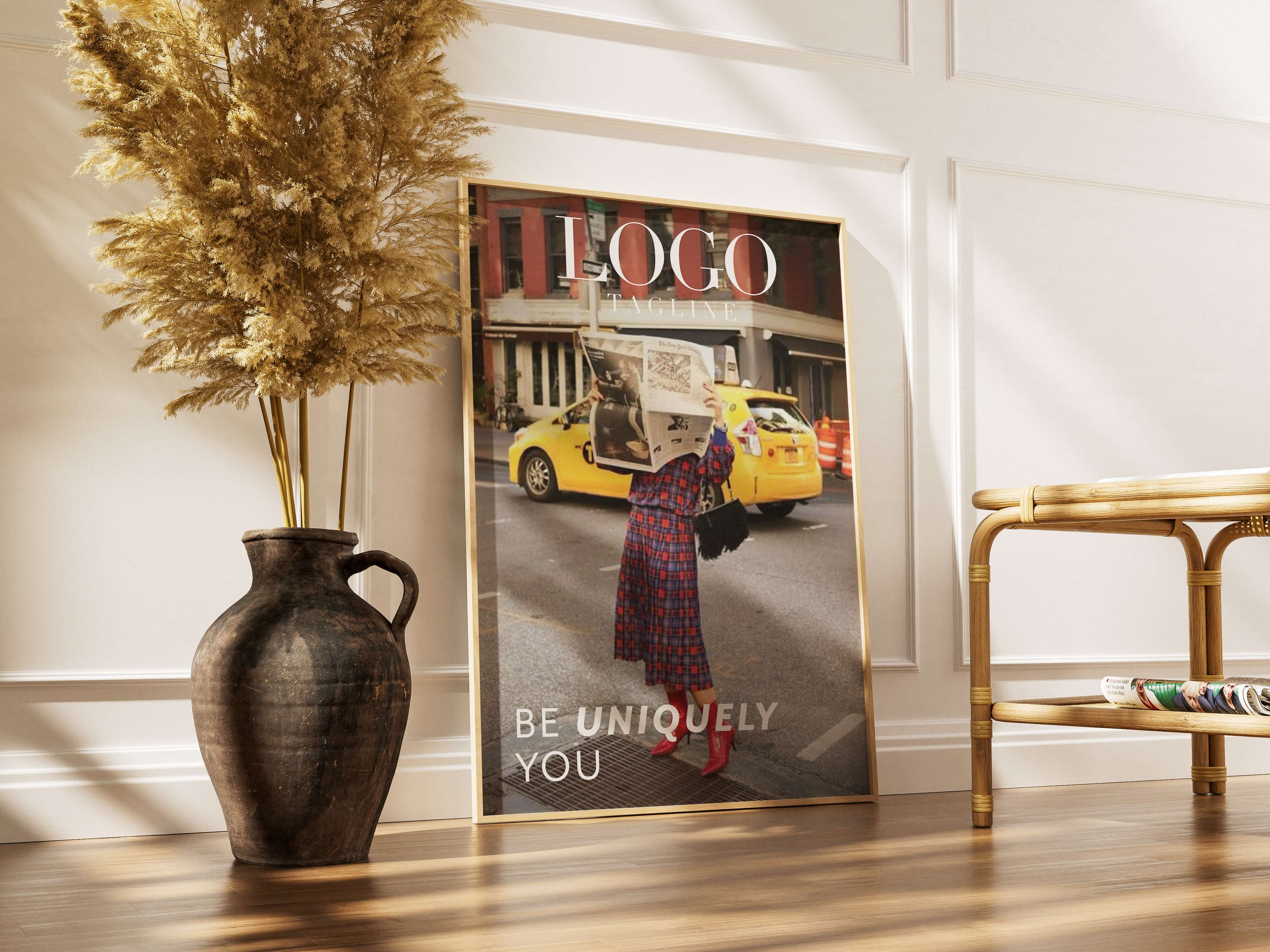 Poster leaning against a wall on the ground of a woman reading a newspaper in front of a taxi, with a plant next to it