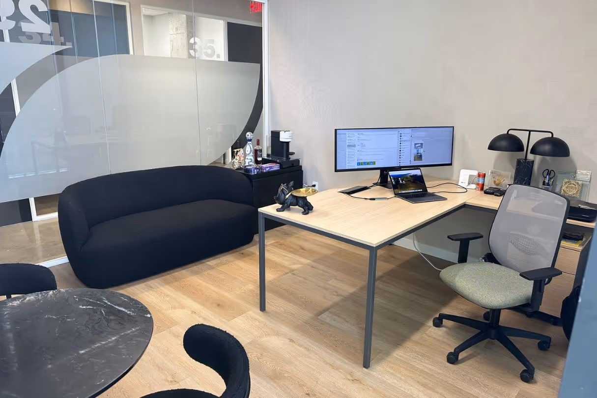 Spacious and furnished executive suite at The Worx Orlando, featuring a large desk, ergonomic chair, and modern decor