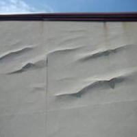 exterior stucco bulging