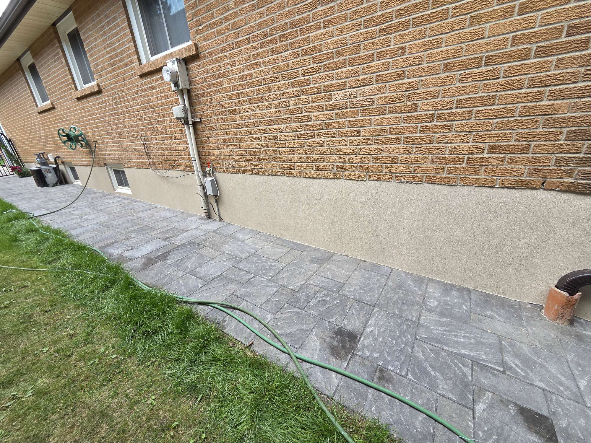 side of the house with foundation parging stucco finish