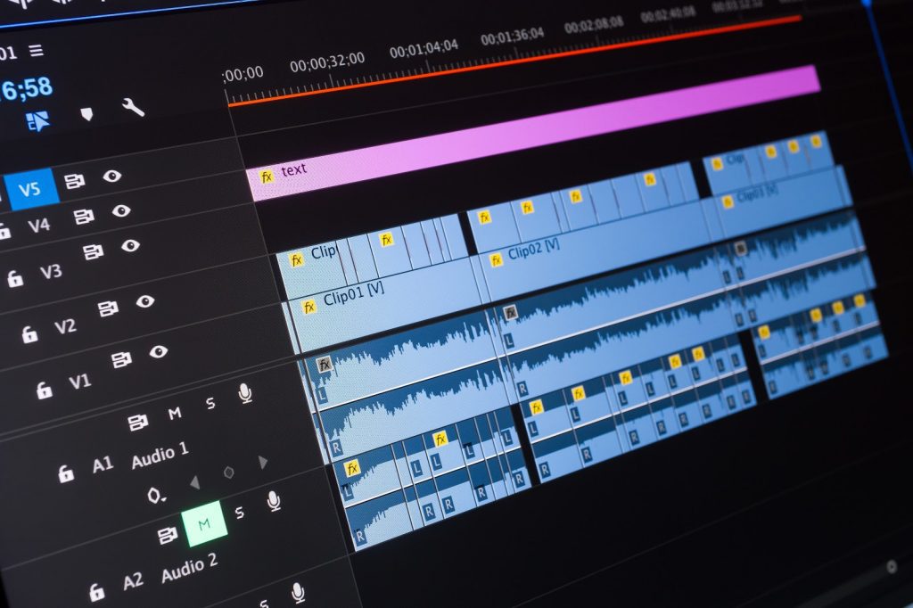 Detailed video editing timeline with layered video and audio clips, including color-coded markers and effects in a professional editing software.