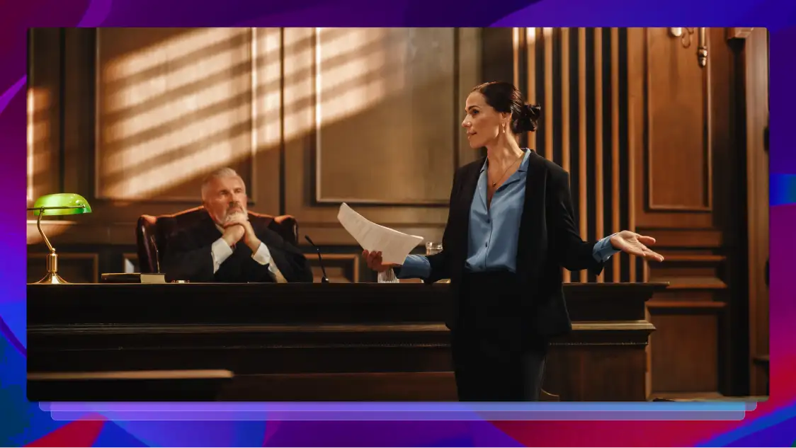 Attorney holding notes and speaking in front of a judge in a courtroom.