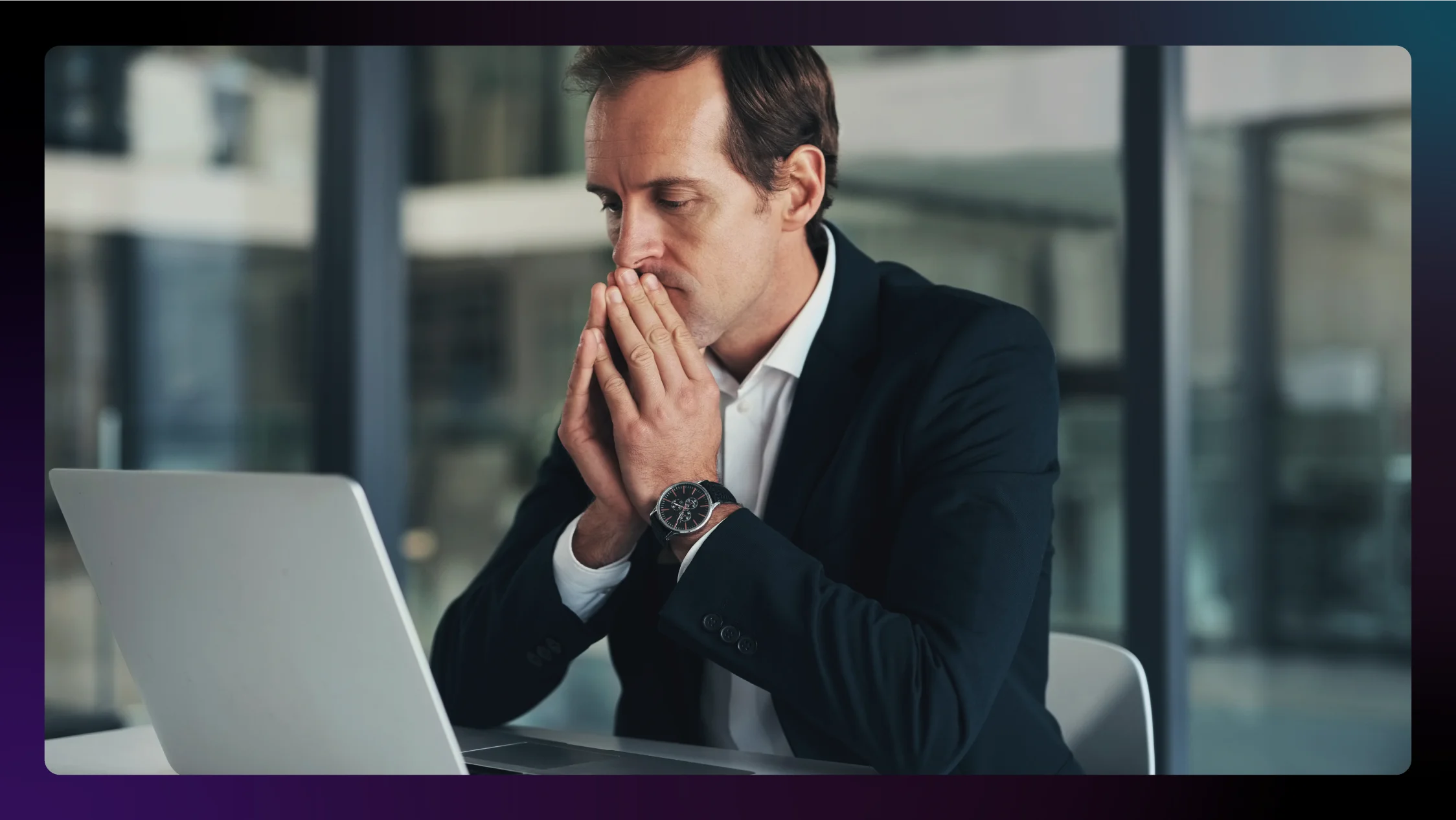 A photo of a lawyer experiencing burnout in an office in front of a laptop.