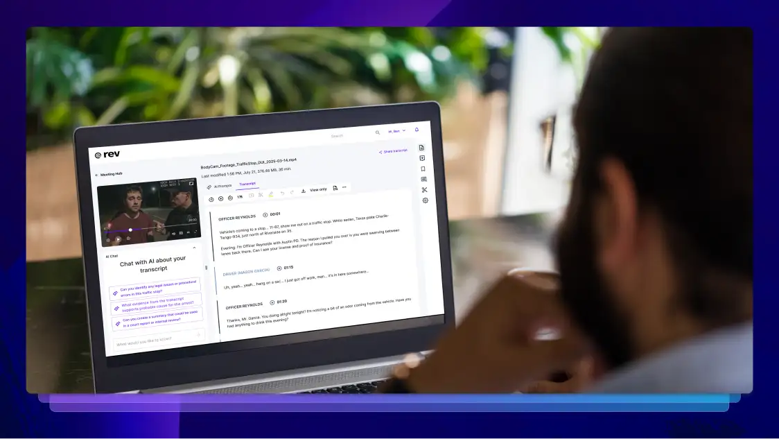 A bearded person reviewing a Rev legal transcript on a laptop screen.