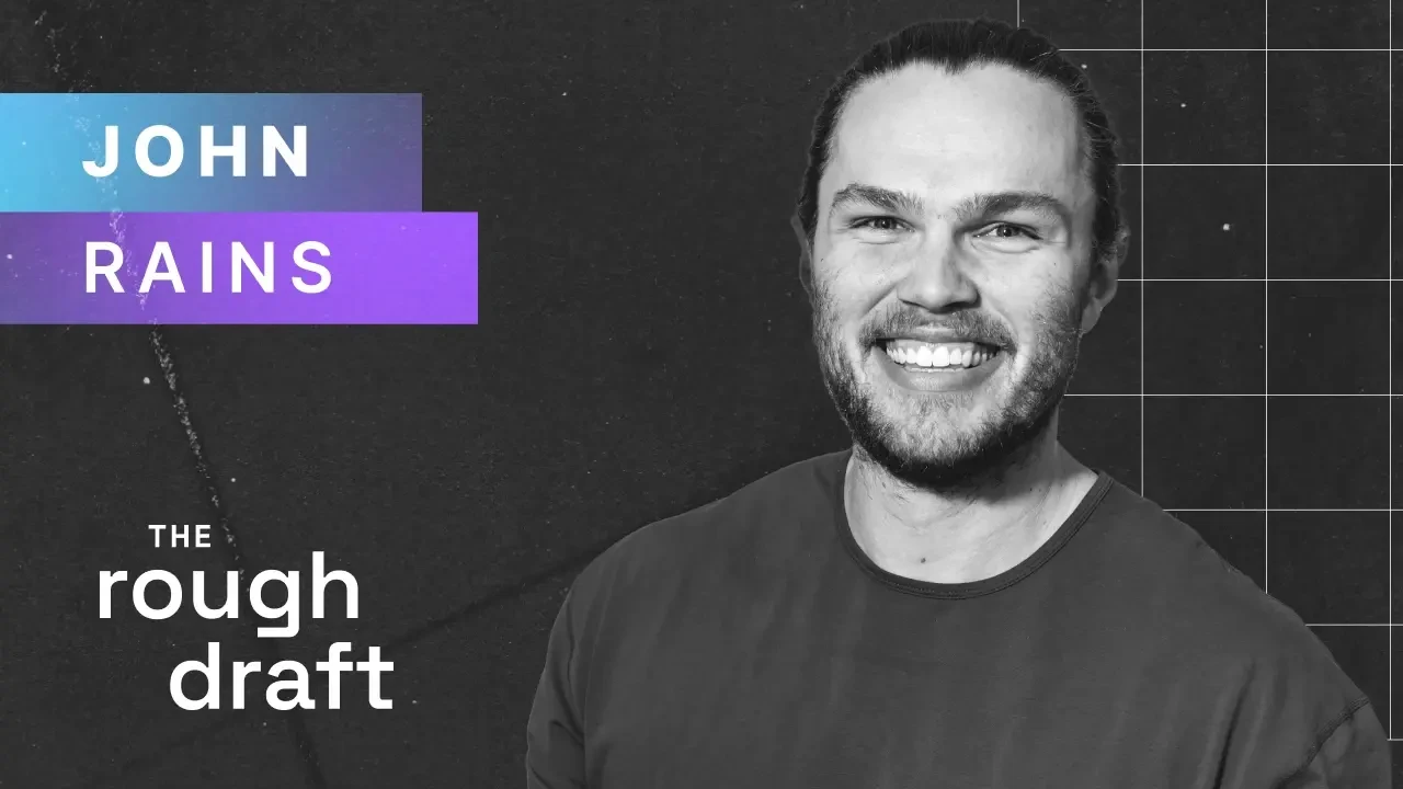 Professional headshot of person smiling in business attire against a neutral background