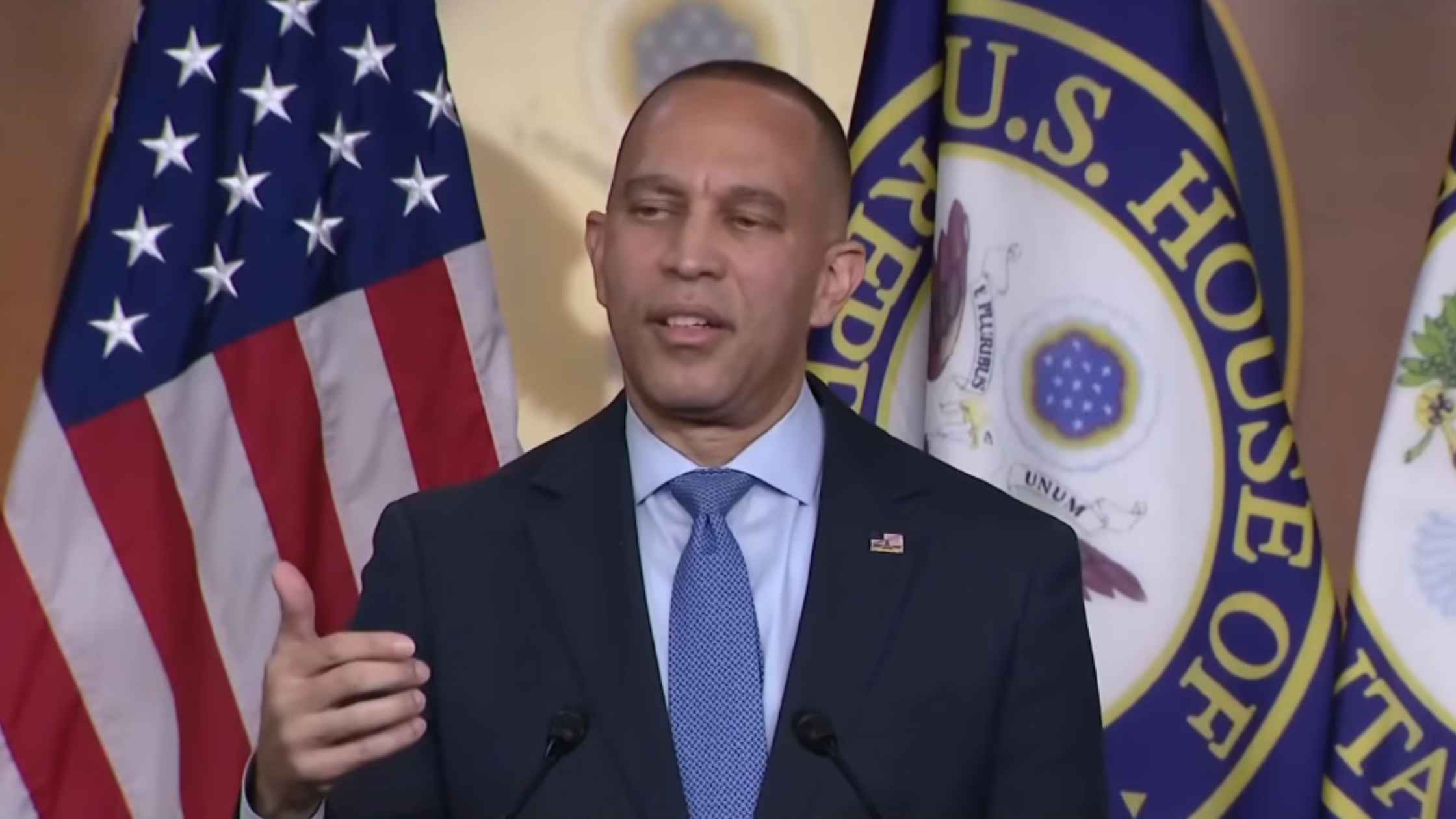 Hakeem Jeffries speaks and gestures to press. 