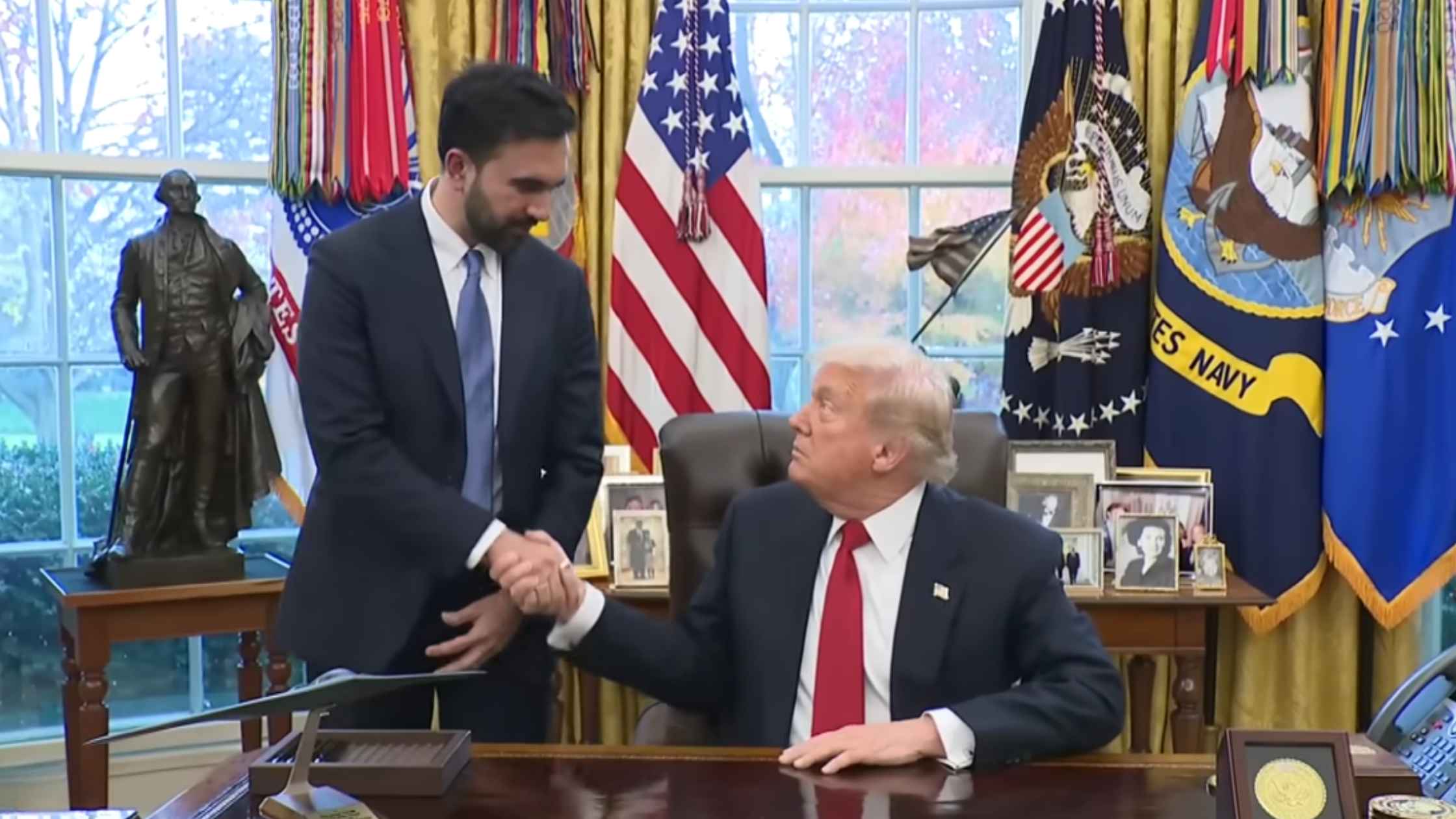 Trump and Mmdanmi shake hands. 