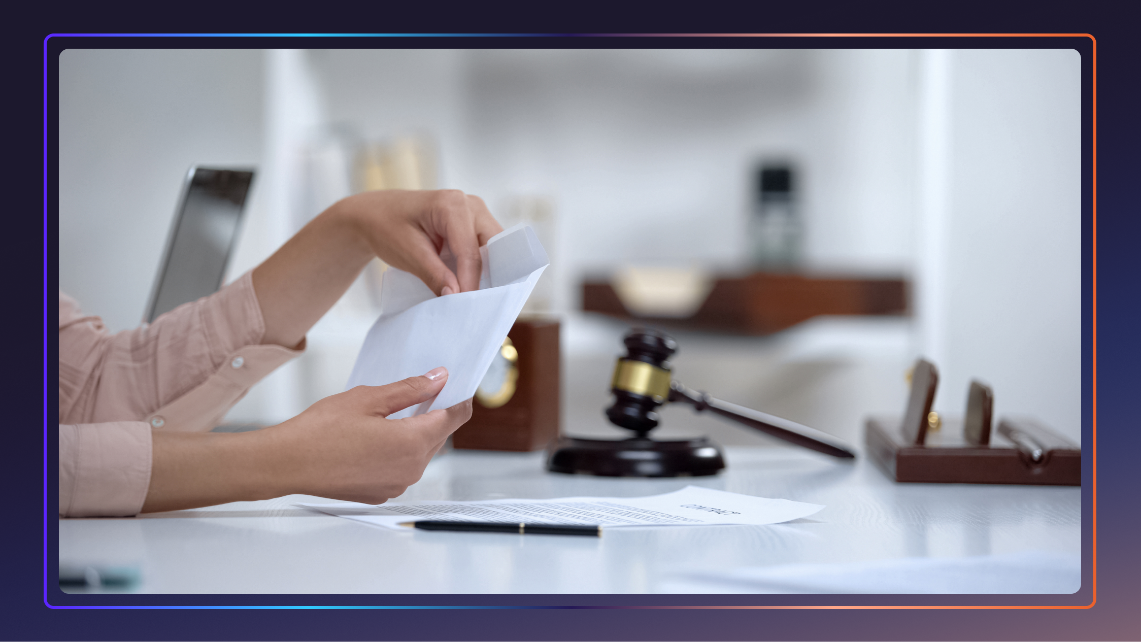 A woman’s hands opening a letter at a desk by a judge’s gavel.